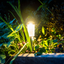 garden design St Catharines - 6 Common Landscaping Errors (and How to Avoid Them) - a garden light on the edge of a raised garden bed made of concrete