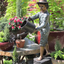 garden design St Catharines - 6 Common Landscaping Errors (and How to Avoid Them) - a garden statue of a boy with a watering can